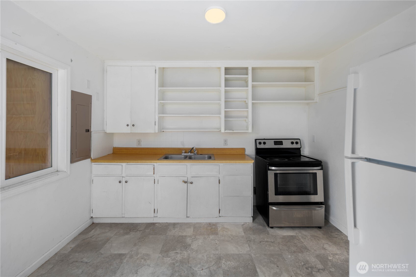 1218 South Ridgewood Avenue Tacoma, WA 98405 - Photo 16 of 24 a kitchen with white cabinets and appliances