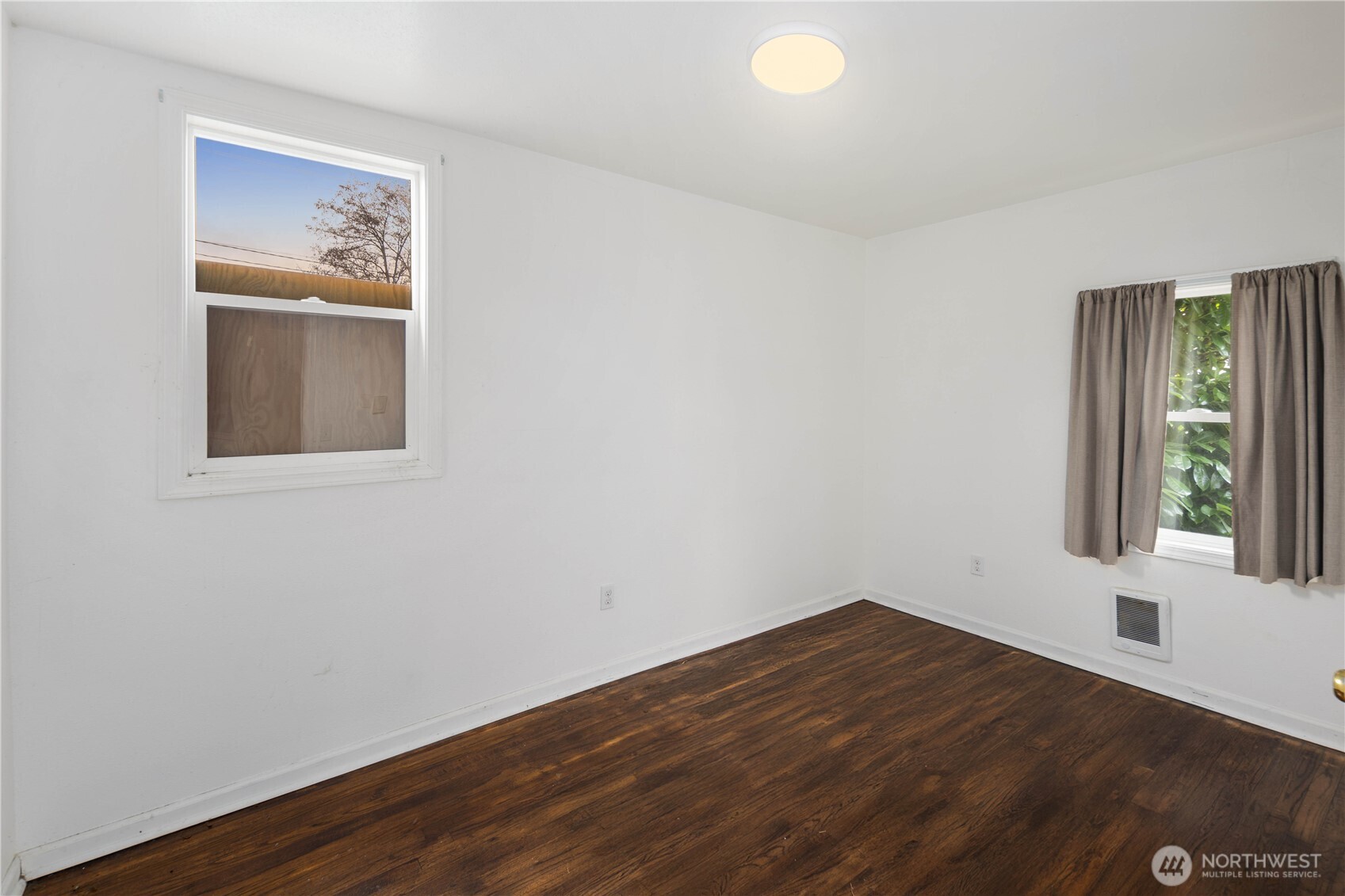 1218 South Ridgewood Avenue Tacoma, WA 98405 - Photo 9 of 24 a view of an empty room with wooden floor and a window