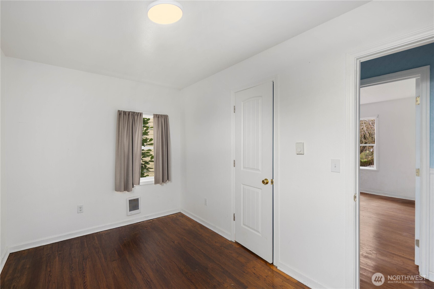 1218 South Ridgewood Avenue Tacoma, WA 98405 - Photo 10 of 24 an empty room with wooden floor and windows