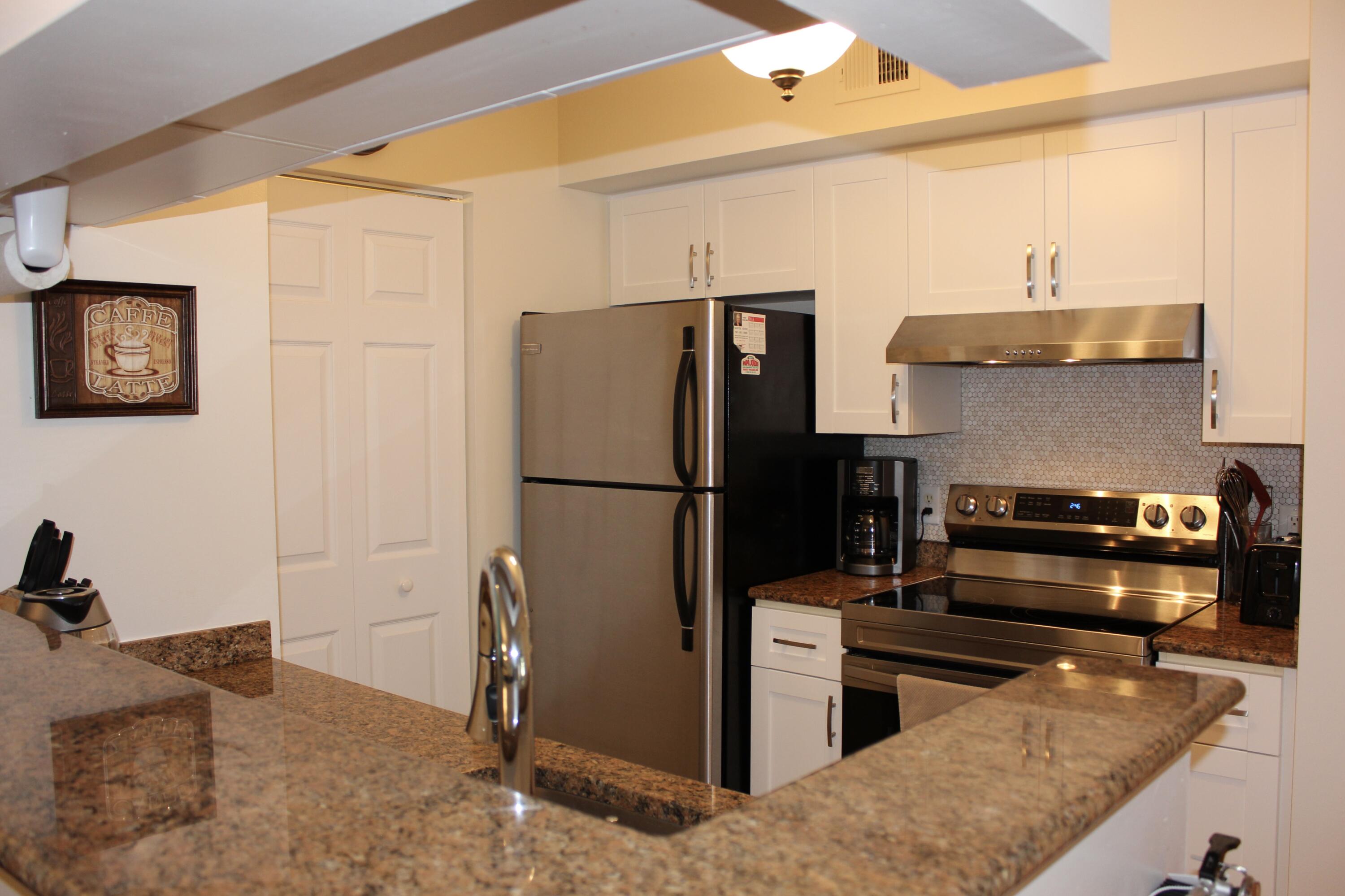 3302 Tuscany Way Boynton Beach, FL 33435 - Photo 16 of 62 a kitchen with a refrigerator and a stove top oven