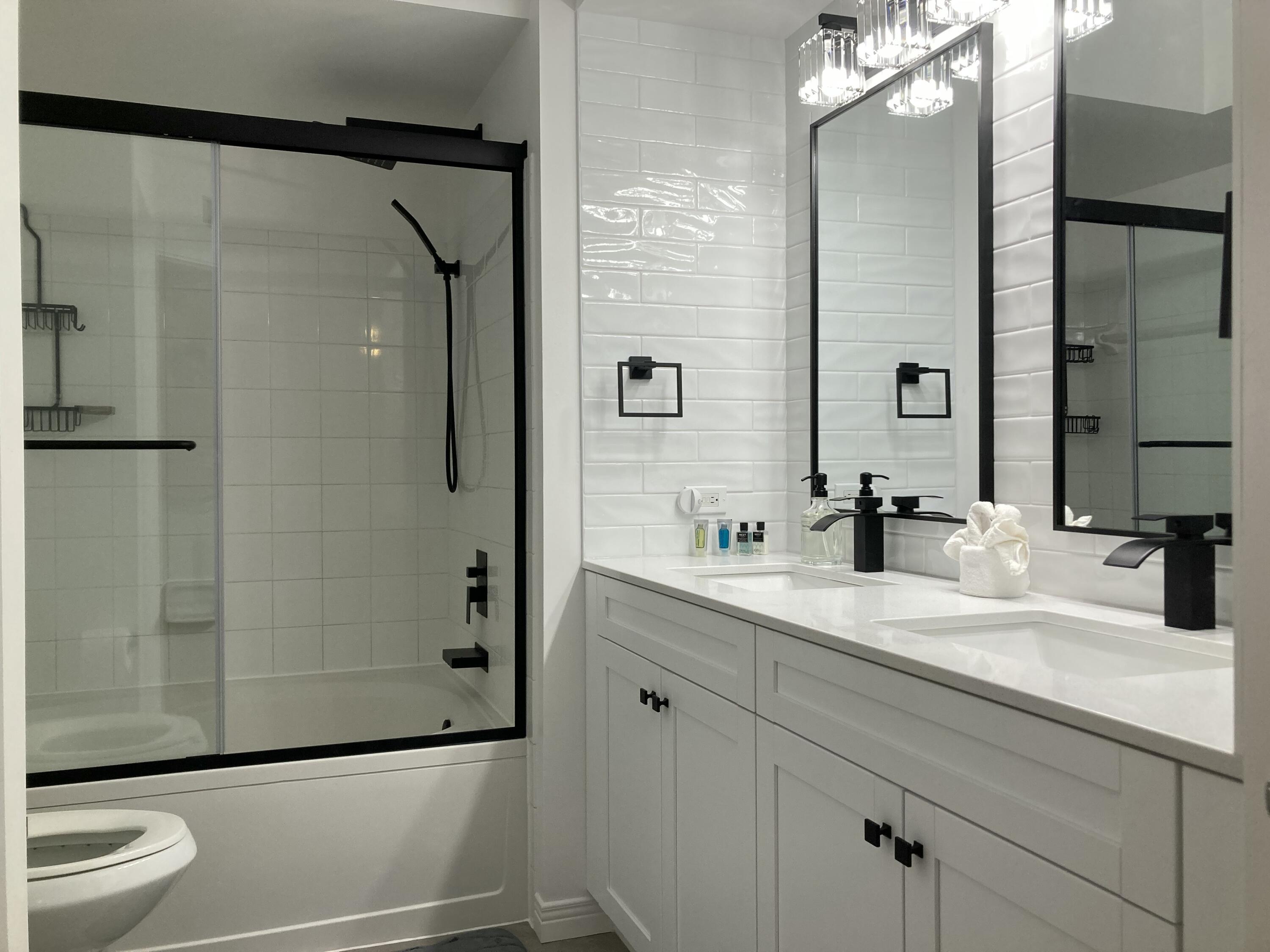 3302 Tuscany Way Boynton Beach, FL 33435 - Photo 20 of 62 a bathroom with a granite countertop sink a toilet and shower