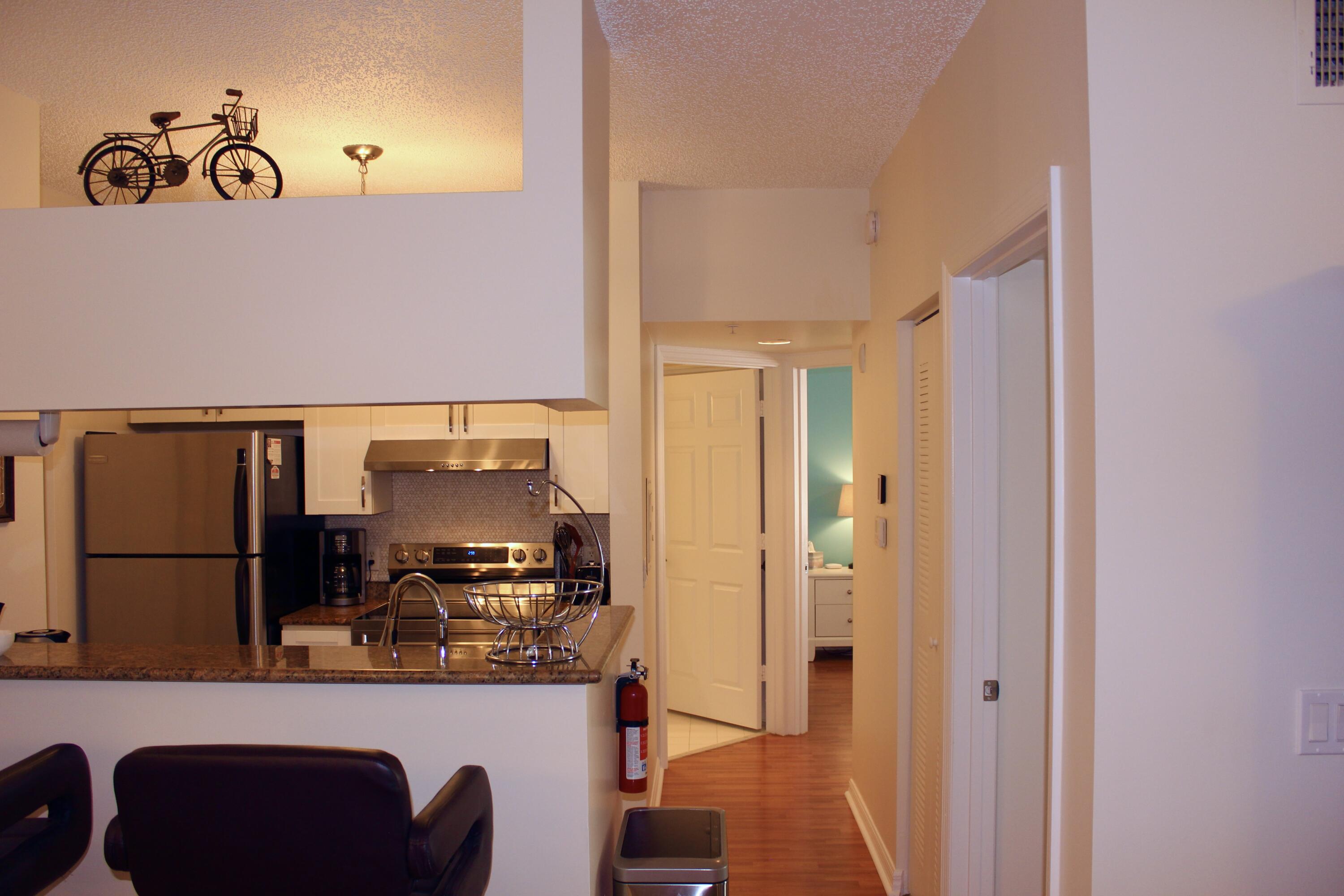 3302 Tuscany Way Boynton Beach, FL 33435 - Photo 23 of 62 a kitchen with a refrigerator and a table