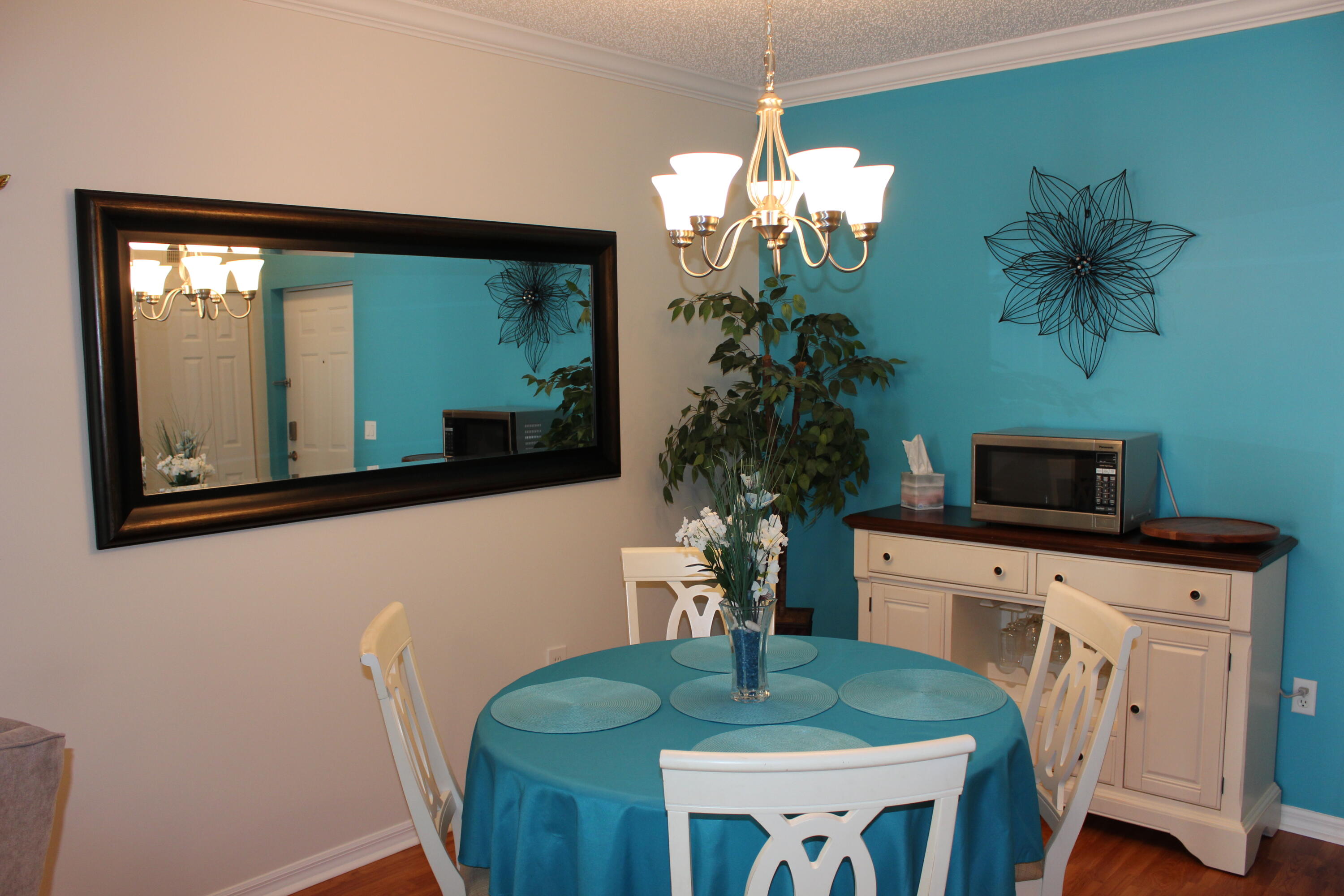 3302 Tuscany Way Boynton Beach, FL 33435 - Photo 31 of 62 a kitchen with a table chairs and a potted plant