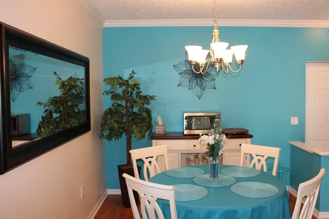 a living room with furniture and potted plants