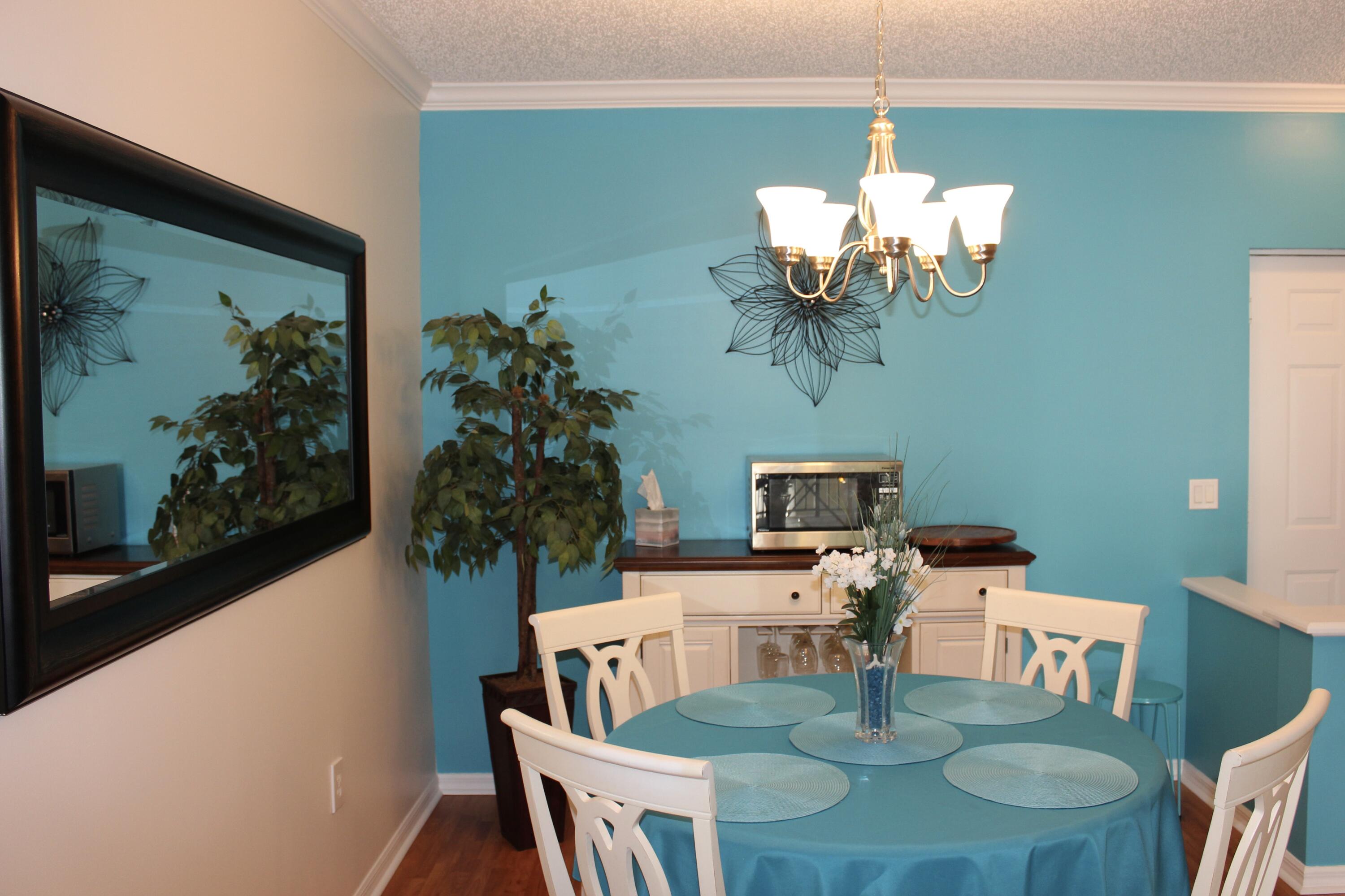 3302 Tuscany Way Boynton Beach, FL 33435 - Photo 32 of 62 a view of a dining room with furniture a chandelier and wooden floor
