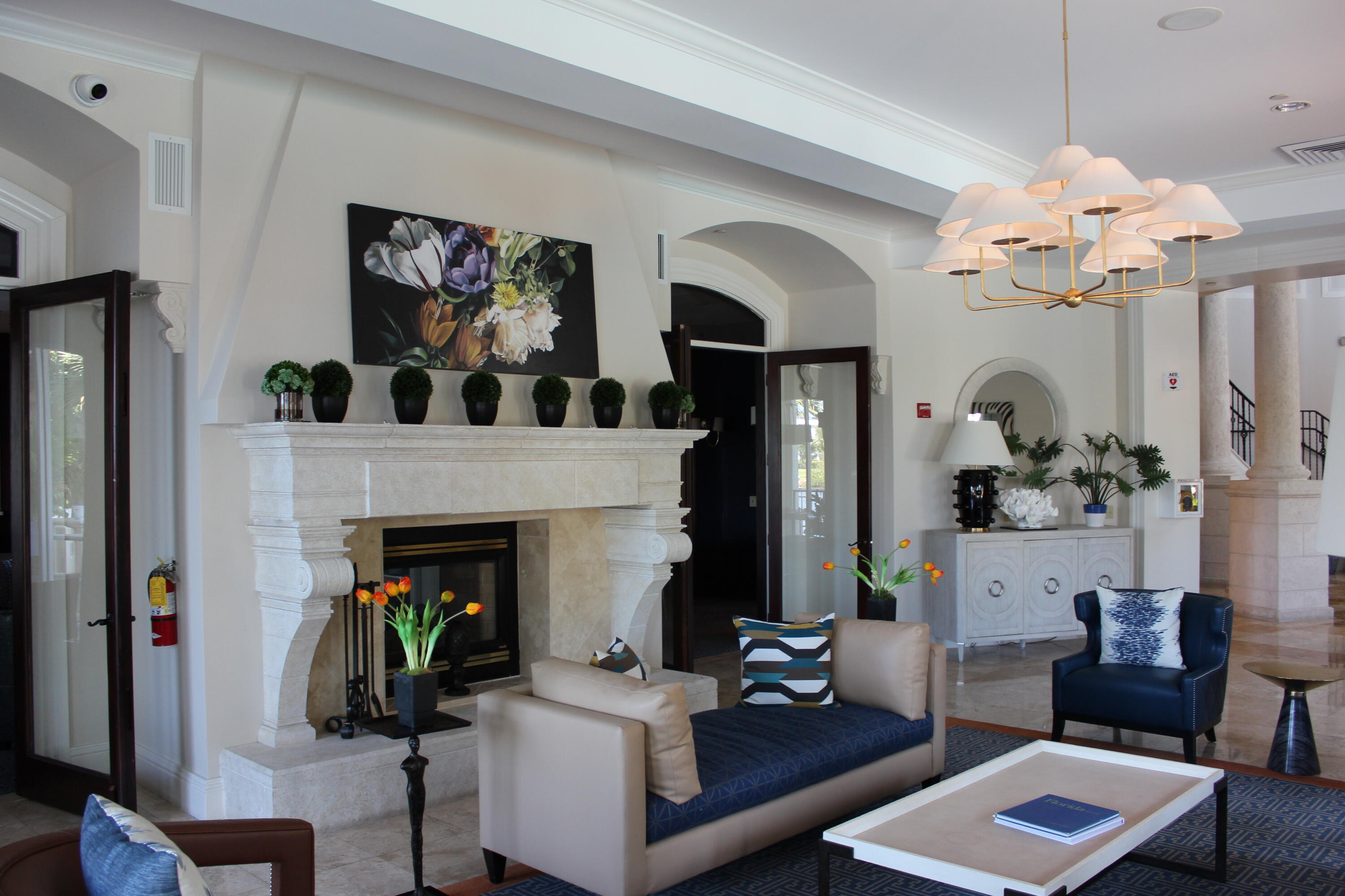 3302 Tuscany Way Boynton Beach, FL 33435 - Photo 54 of 62 a living room with furniture flowers and a fireplace