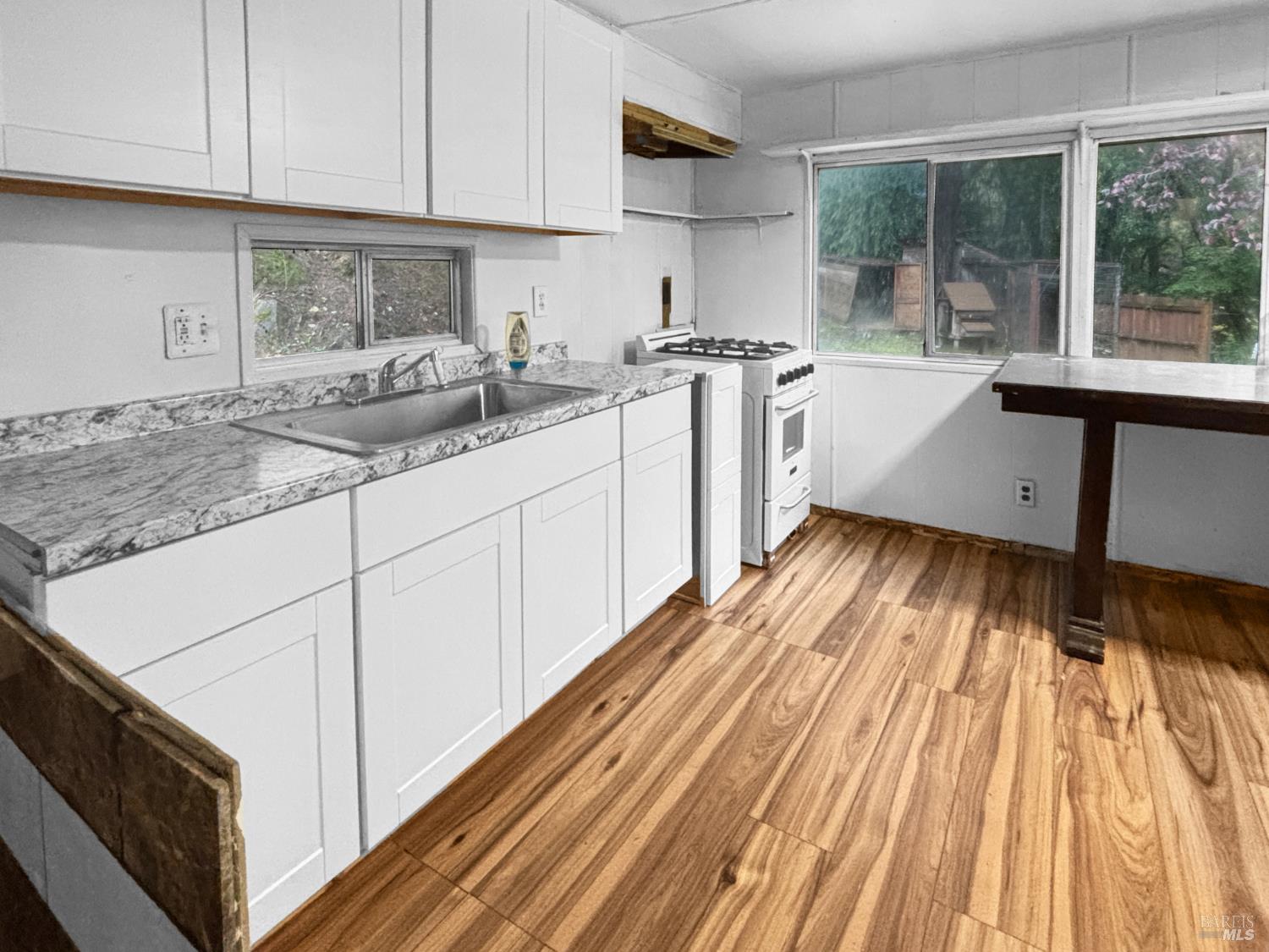 5011 Canyon Road Willits, CA 95490 - Photo 9 of 16 a kitchen with sink cabinets and window