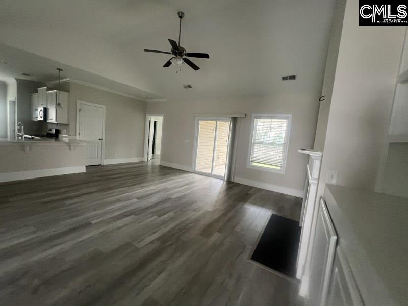 516 Mitscher Way Chapin, SC 29036 - Photo 3 of 18 wooden floor in an empty room with a window