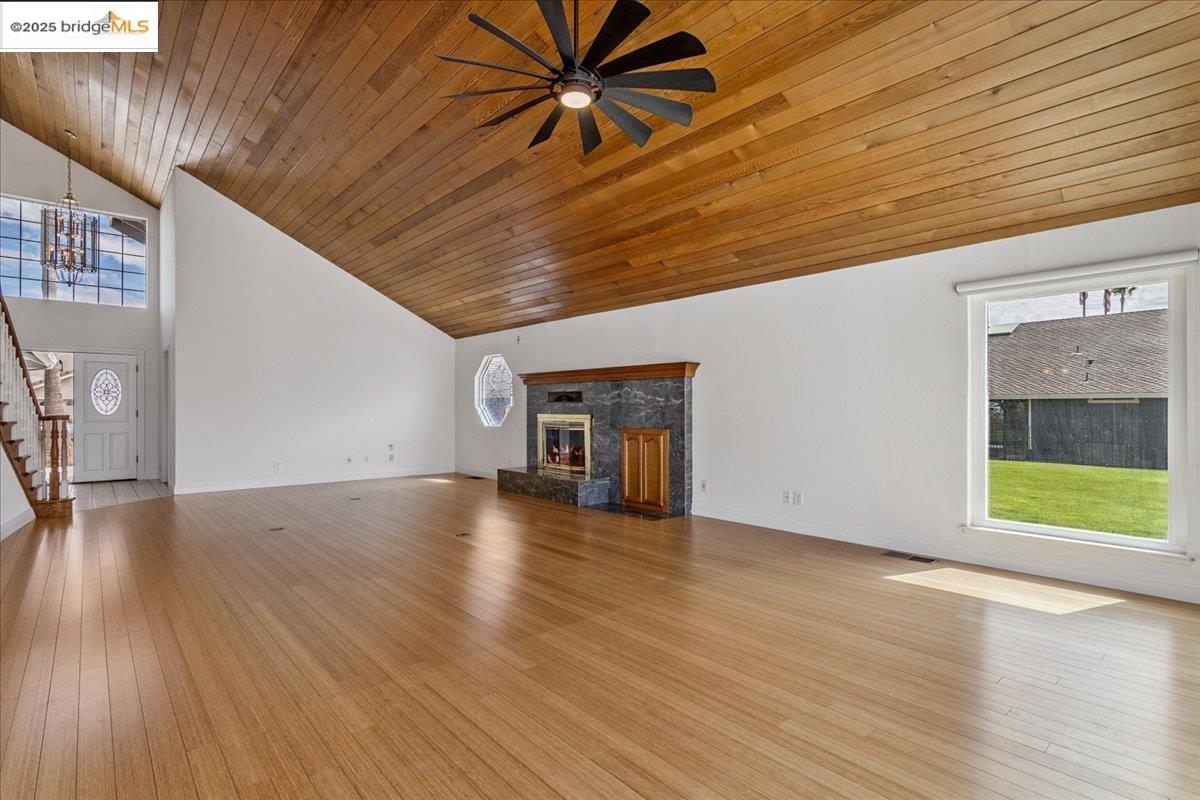 5752 Drakes Drive Discovery Bay, CA 94505 - Photo 11 of 32 Unfurnished living room with wooden ceiling, high vaulted ceiling, stairway, light wood-style flooring, and a ceiling fan