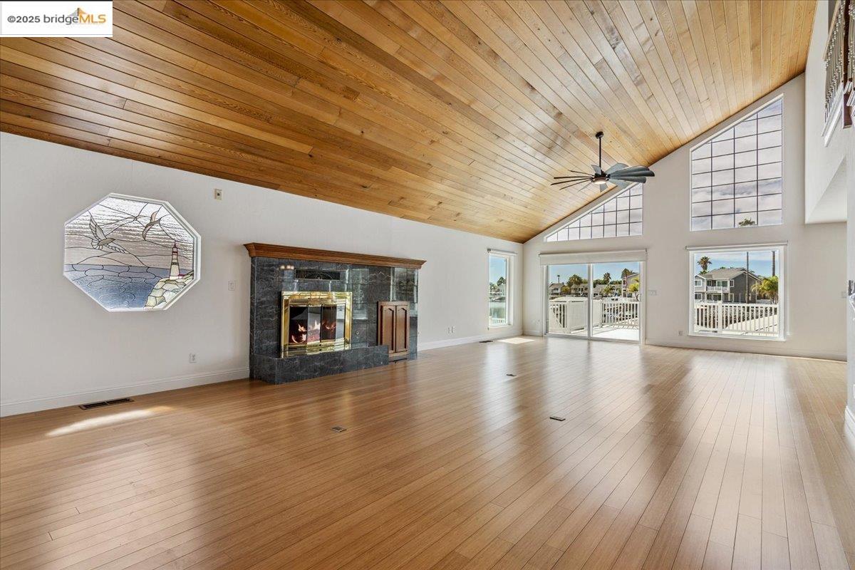 5752 Drakes Drive Discovery Bay, CA 94505 - Photo 12 of 32 an empty room with wooden floor and windows