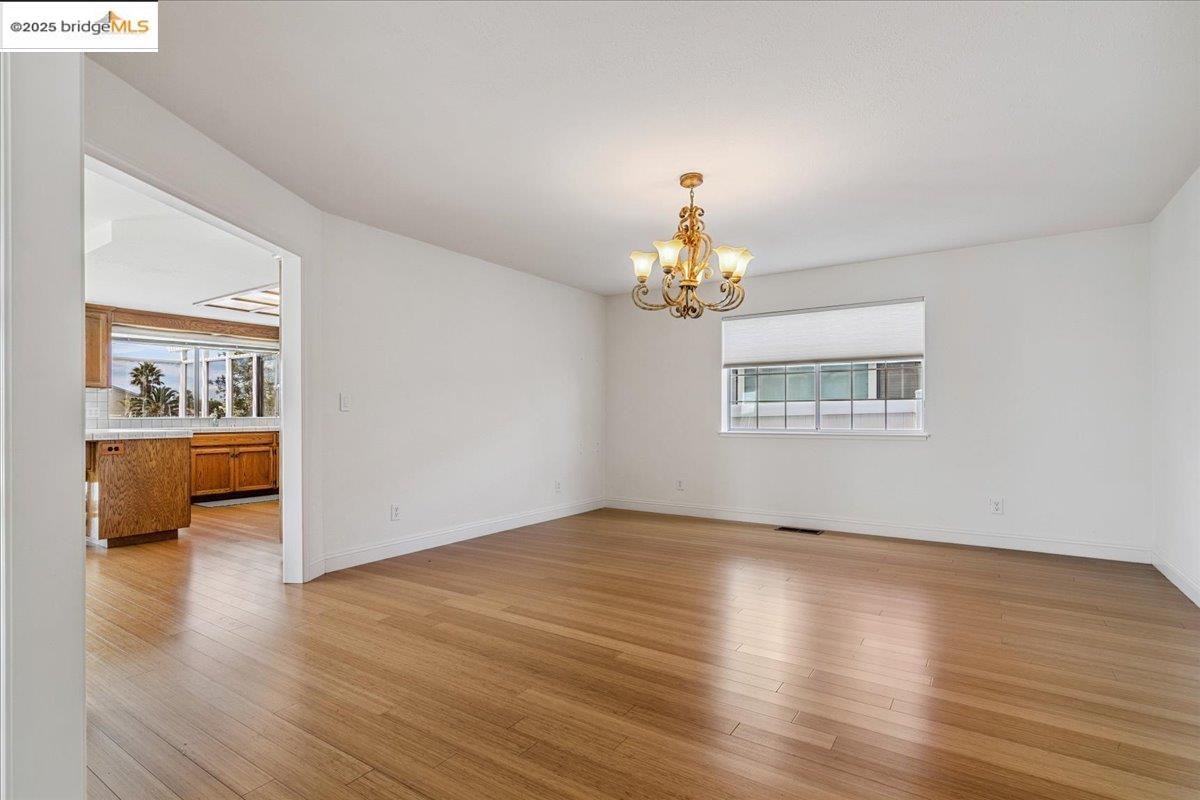 5752 Drakes Drive Discovery Bay, CA 94505 - Photo 14 of 32 a view of an empty room with a window and wooden floor