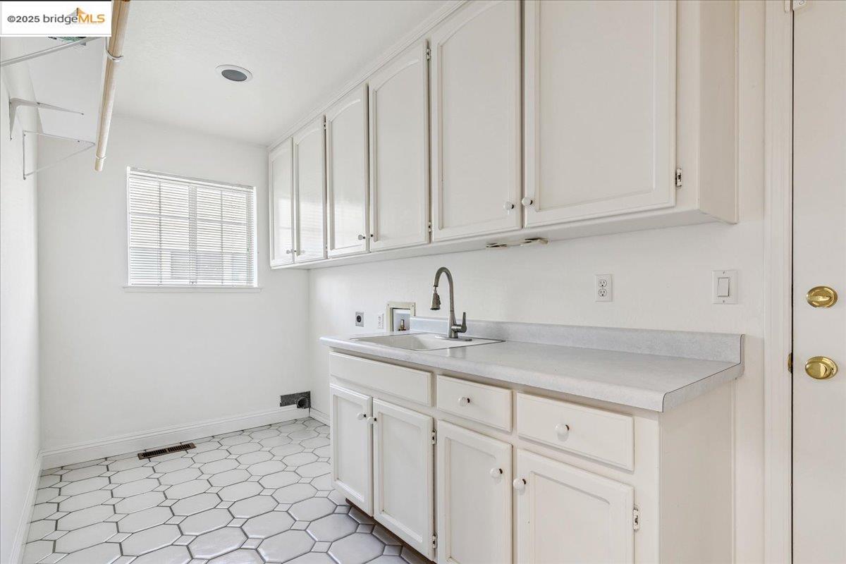 5752 Drakes Drive Discovery Bay, CA 94505 - Photo 21 of 32 a kitchen with a sink and cabinets