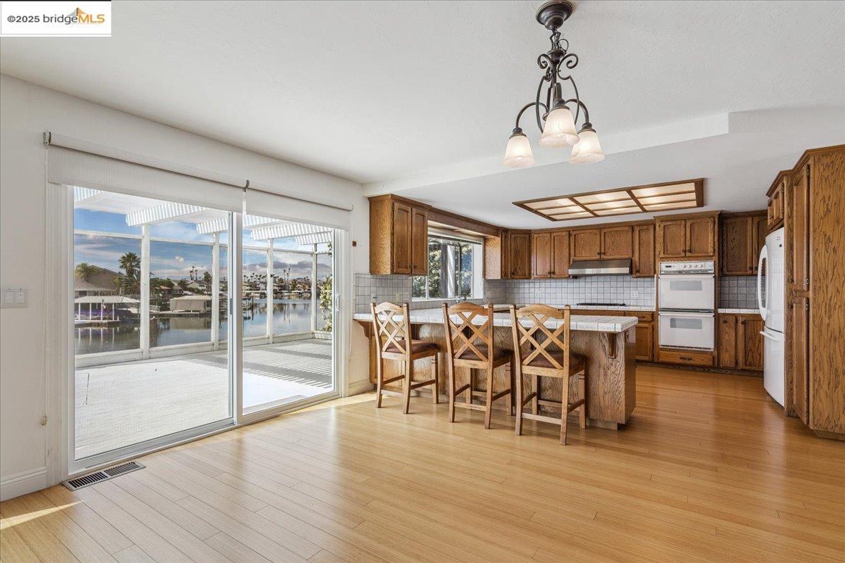 5752 Drakes Drive Discovery Bay, CA 94505 - Photo 7 of 32 a view of a dining room with furniture window and wooden floor