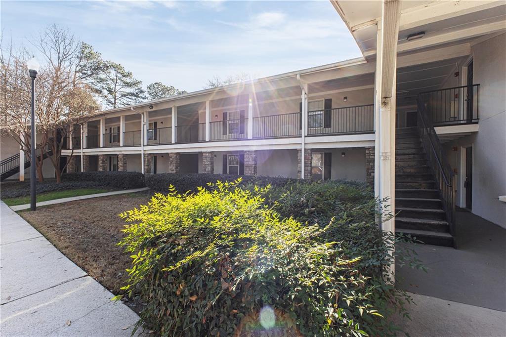 1150 Collier Road Northwest, Unit K9 Atlanta, GA 30318 - Photo 20 of 28 a front view of a house with a yard