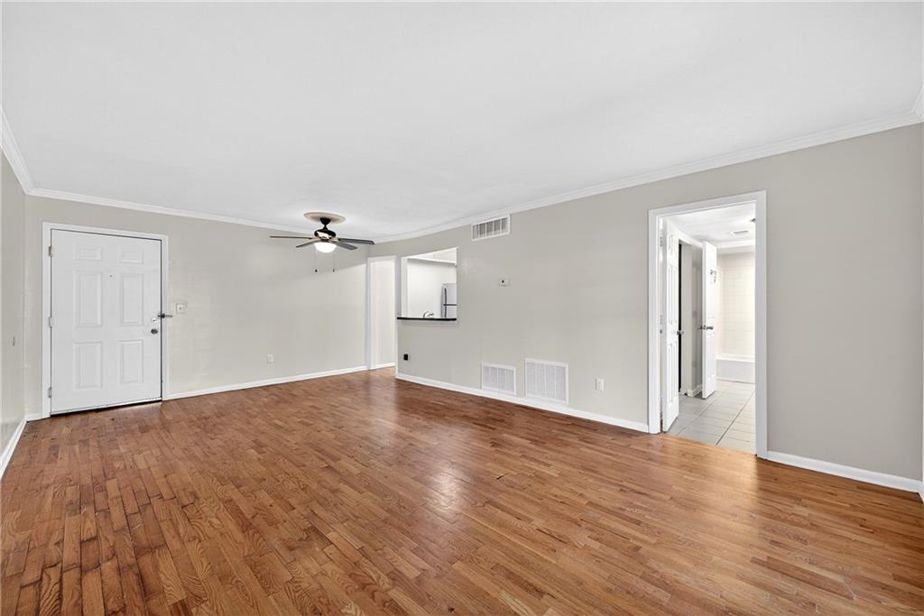 1150 Collier Road Northwest, Unit K9 Atlanta, GA 30318 - Photo 4 of 28 a view of empty room with wooden floor and ceiling fan