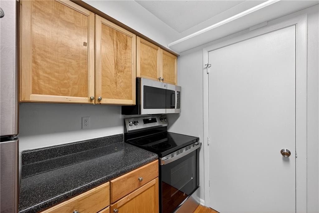 1150 Collier Road Northwest, Unit K9 Atlanta, GA 30318 - Photo 8 of 28 a kitchen with a large window and a sink