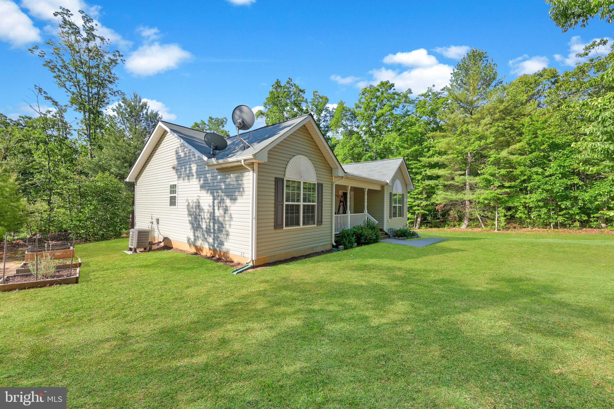 470 Jacoby Road Louisa, VA 23093 - Photo 16 of 16 a view of a house with a yard