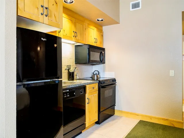 a kitchen with a sink appliances and cabinets