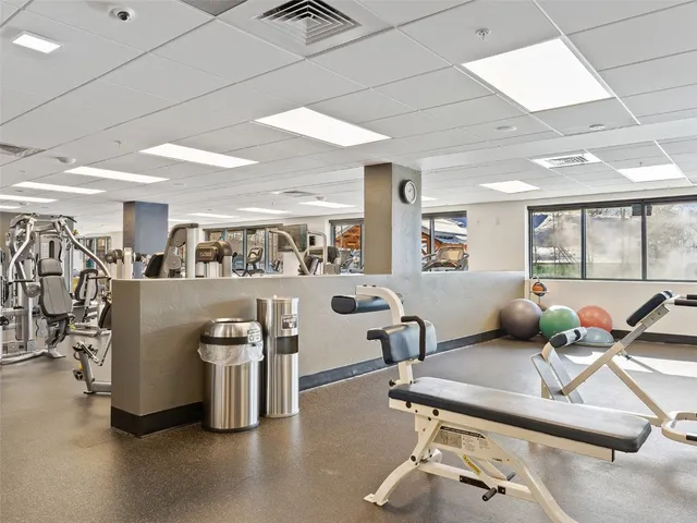 a room with gym equipment and a table