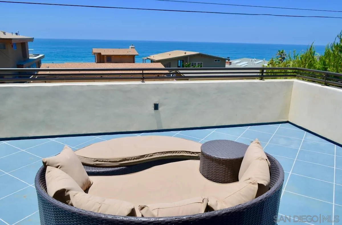 1235 Neptune Avenue Encinitas, CA 92024 - Photo 20 of 32 a table with a chair and a potted plant