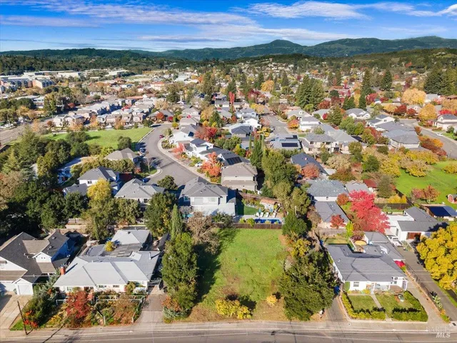 an aerial view of residential houses with outdoor space