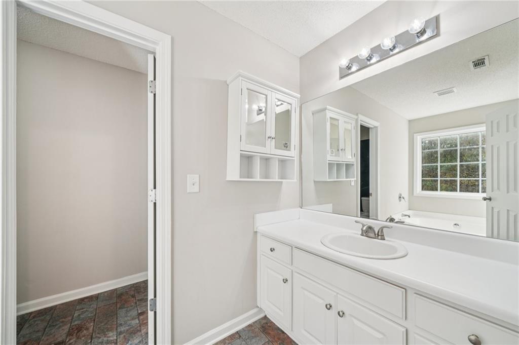 480 Raider Way Bethlehem, GA 30620 - Photo 11 of 30 a bathroom with a sink double vanity and a mirror