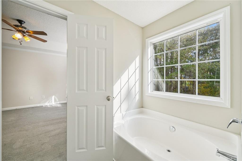 480 Raider Way Bethlehem, GA 30620 - Photo 12 of 30 a white bath tub sitting next to a window
