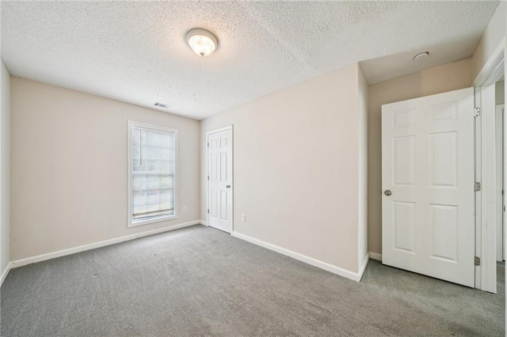 480 Raider Way Bethlehem, GA 30620 - Photo 17 of 30 an empty room with windows and closet