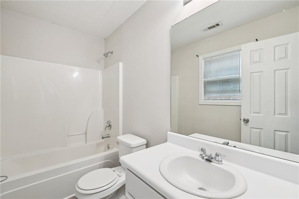 480 Raider Way Bethlehem, GA 30620 - Photo 20 of 30 a bathroom with a toilet a sink and a bathtub