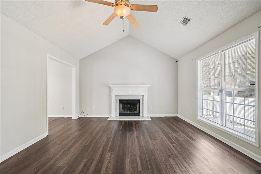 480 Raider Way Bethlehem, GA 30620 - Photo 4 of 30 wooden floor fireplace and windows in an empty room