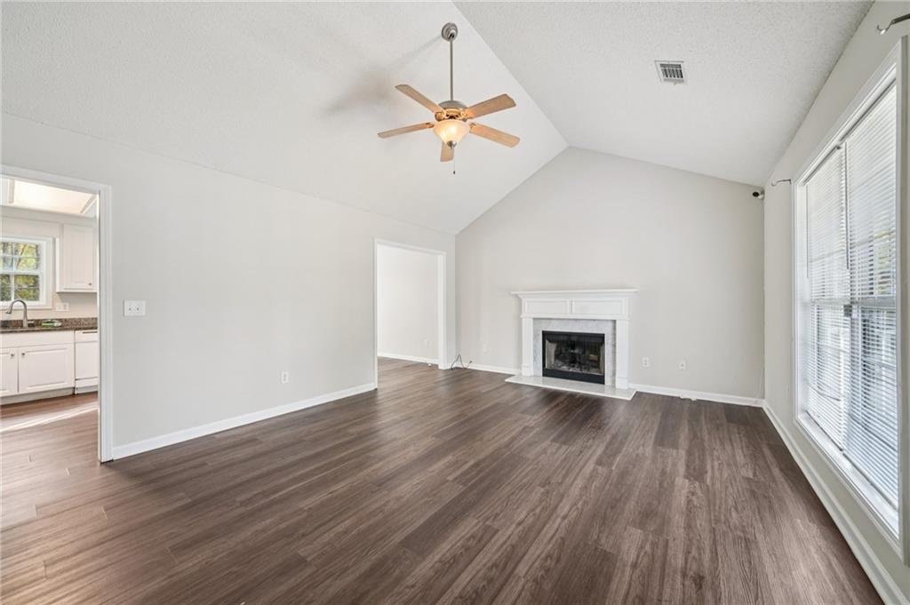 480 Raider Way Bethlehem, GA 30620 - Photo 5 of 30 wooden floor fireplace and natural light in room