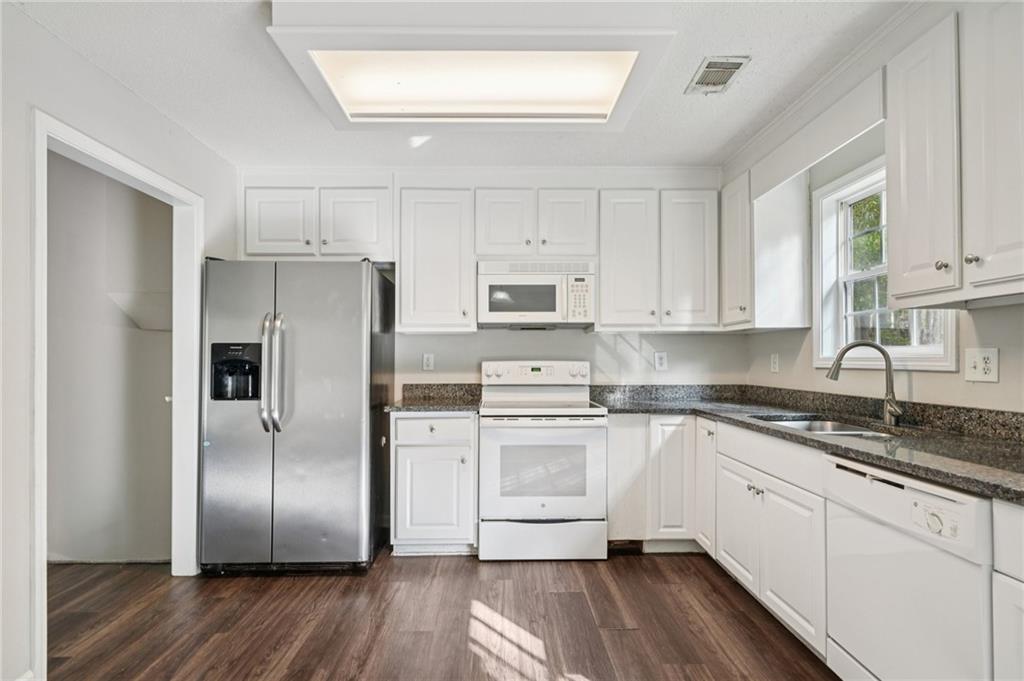 480 Raider Way Bethlehem, GA 30620 - Photo 7 of 30 a kitchen with cabinets stainless steel appliances a sink and a window