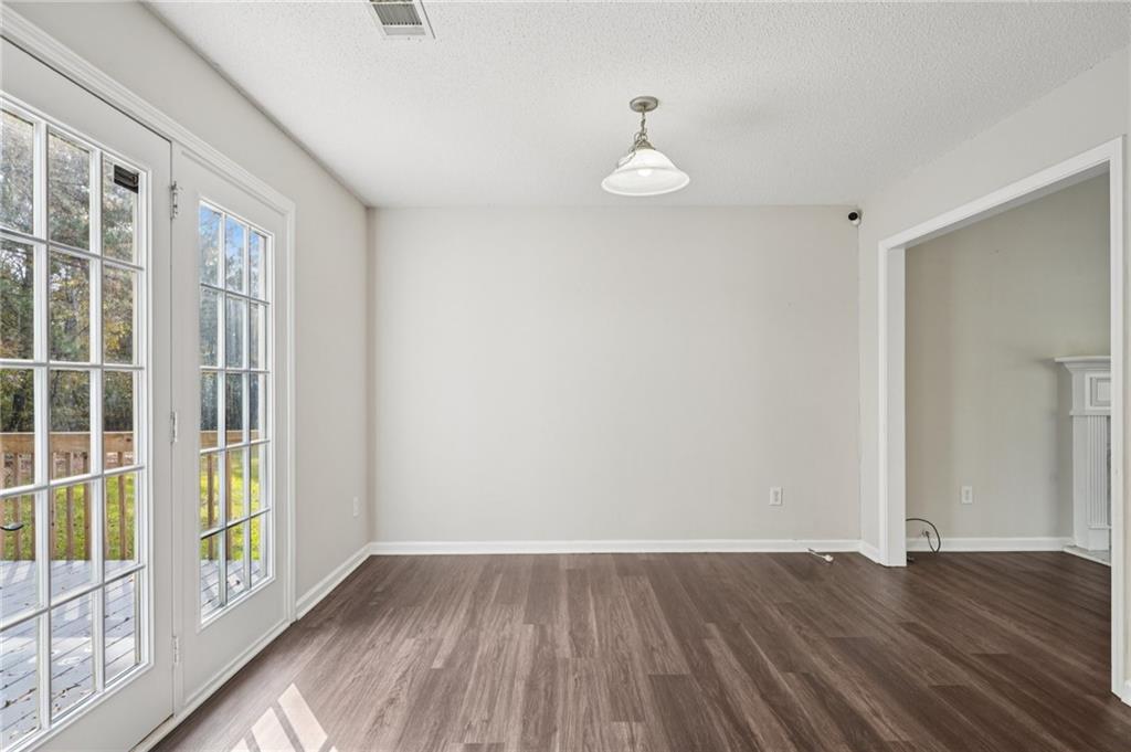480 Raider Way Bethlehem, GA 30620 - Photo 8 of 30 a view of empty room with wooden floor and fan