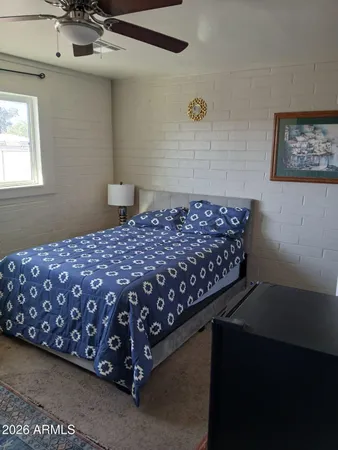 a bedroom with a bed and a dresser