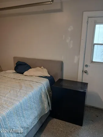 a bedroom with a bed and a window