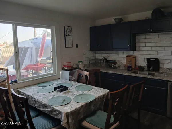 a kitchen with a table chairs stove and microwave