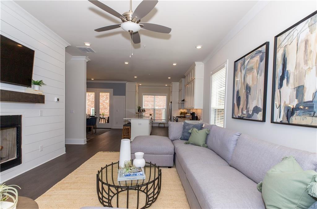 3498 Reaping Ridge, Unit 202 Suwanee, GA 30024 - Photo 1 of 1 a living room with furniture and a flat screen tv
