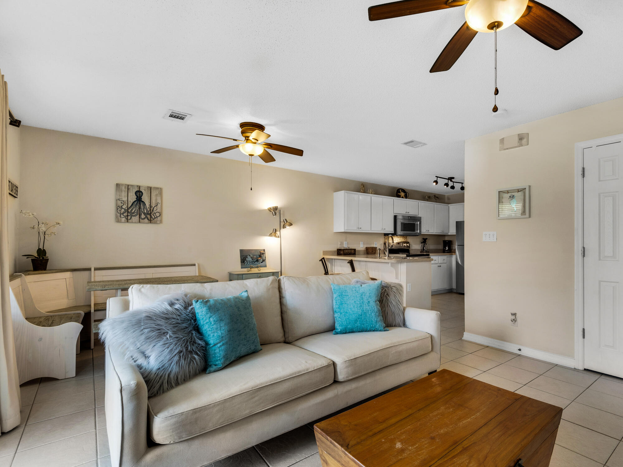 a living room with furniture and kitchen view