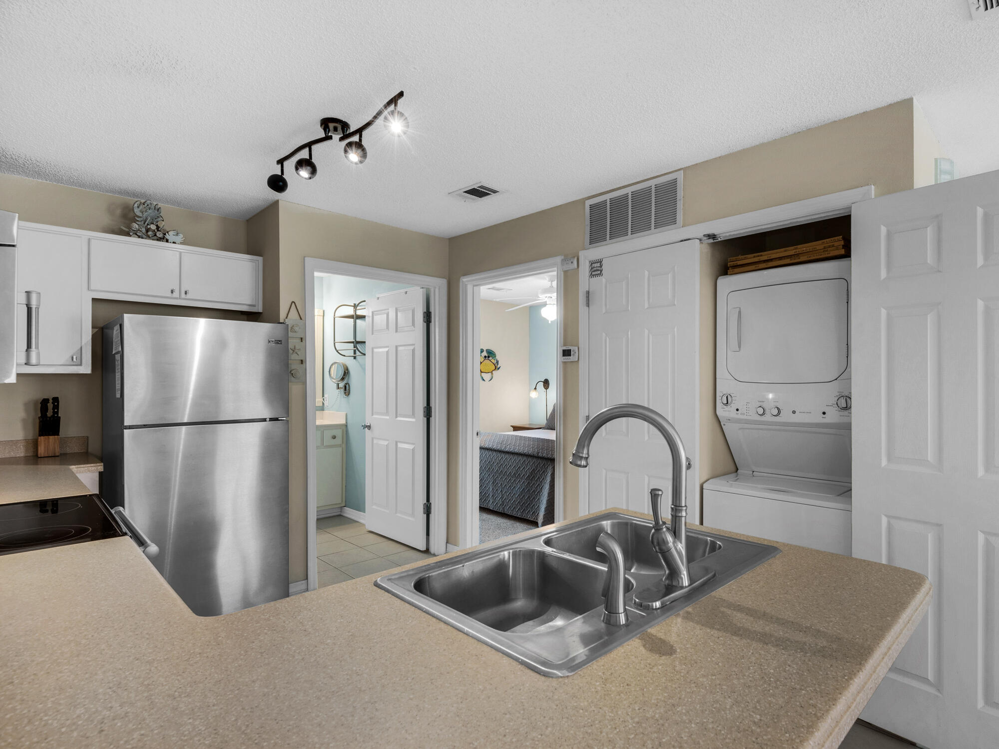 82 Sugar Sand Lane, Unit C2 Santa Rosa Beach, FL 32459 - Photo 12 of 34 a kitchen with a refrigerator and a sink