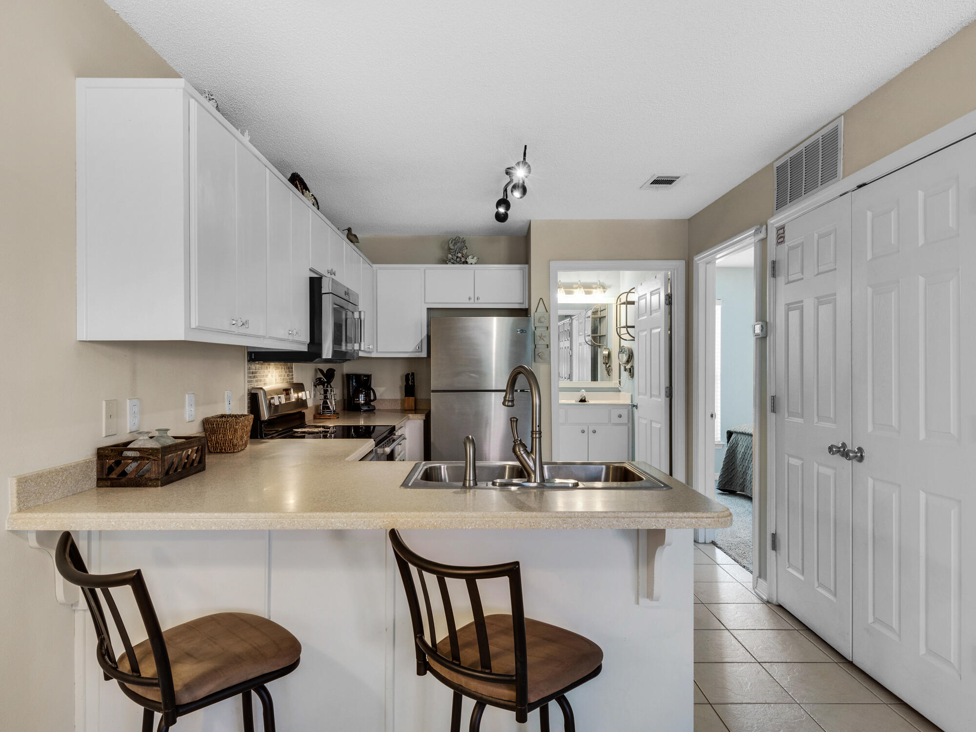 82 Sugar Sand Lane, Unit C2 Santa Rosa Beach, FL 32459 - Photo 9 of 34 a kitchen with stainless steel appliances granite countertop a sink refrigerator and cabinets