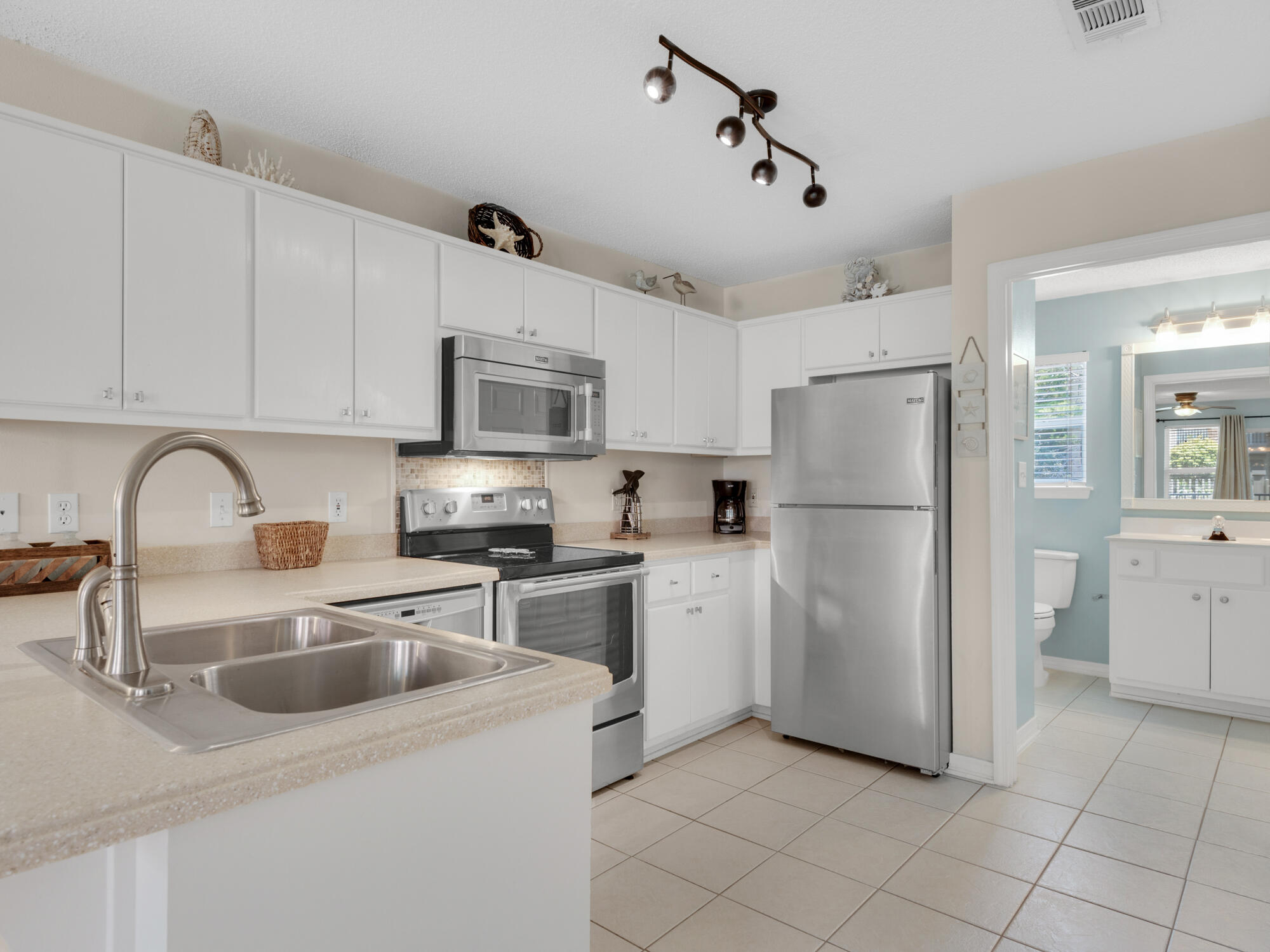 82 Sugar Sand Lane, Unit C2 Santa Rosa Beach, FL 32459 - Photo 10 of 34 a kitchen with refrigerator cabinets and a sink