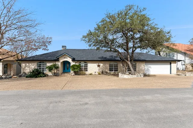 a view of a house with a yard and garage