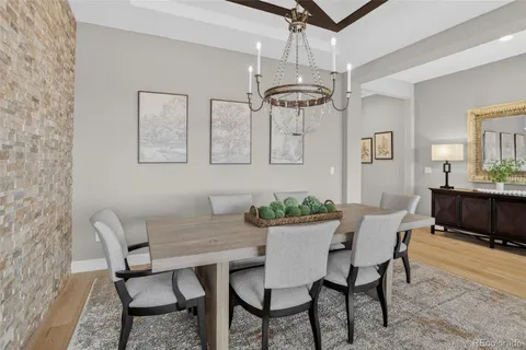 a view of a dining room with furniture and chandelier