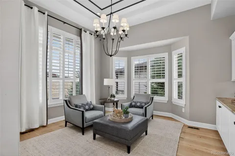 a living room with furniture and a chandelier