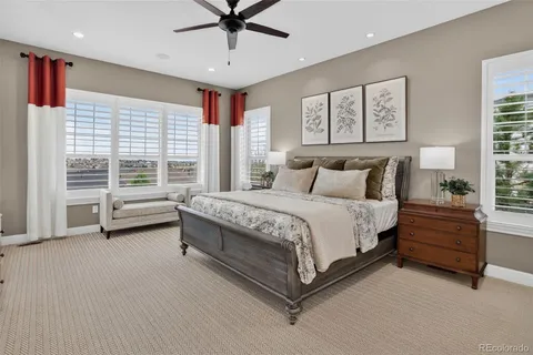 a spacious bedroom with a bed and a large window