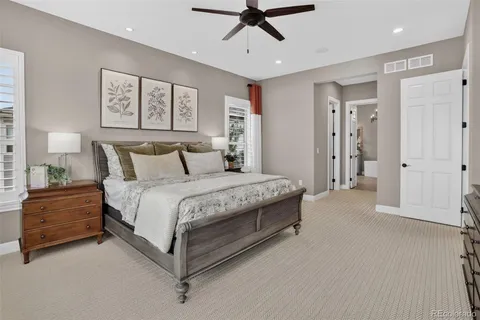 a spacious bedroom with a bed and a chandelier