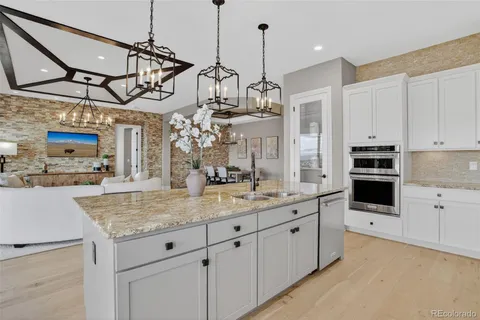 a kitchen with stainless steel appliances granite countertop a sink a counter space and cabinets