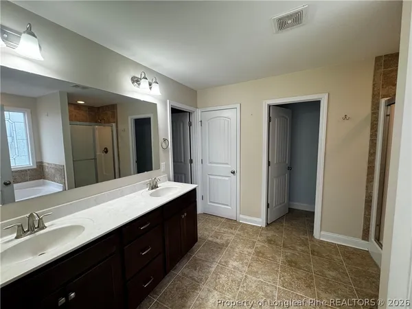 a spacious bathroom with a double vanity sink mirror and double