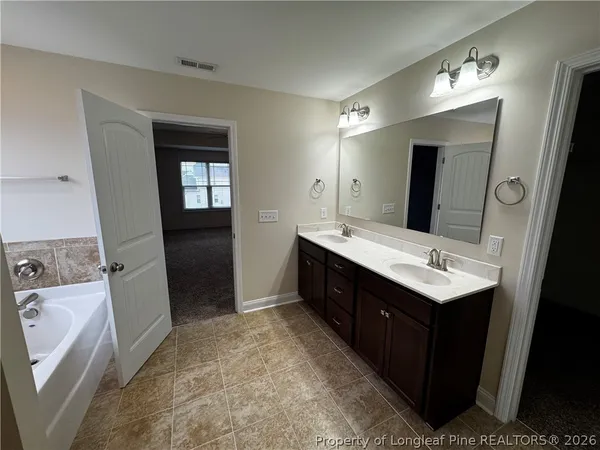 a bathroom with a sink vanity and mirror