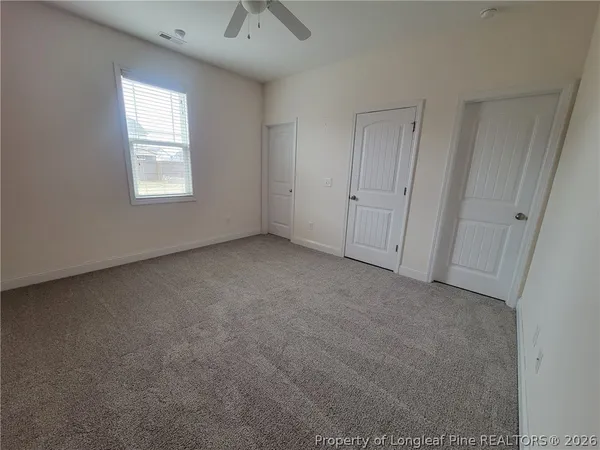 an empty room with windows and closet